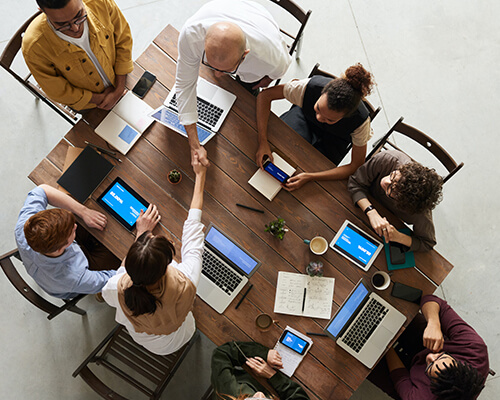 eight people sitting around a conference table